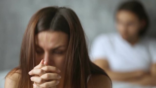 Worried upset woman feeling offended frustrated after quarrel, thinking of breaking up or divorce, distraught couple experiencing betrayal misunderstanding, having problems in difficult relationships