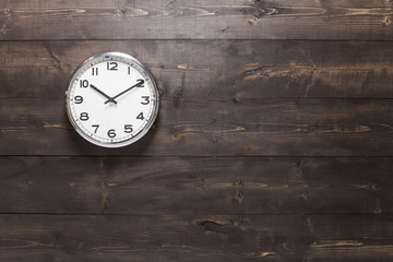 Wall clock on wooden background