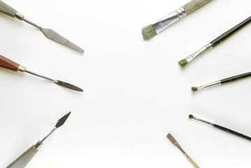 spatulas and brushes to paint on a yellow background