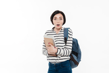 Portrait of a surprised pretty teenage girl with backpack