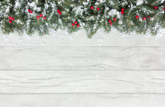 Christmas Border with Snow Covered Red Berries and Fir