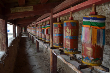 Fototapeta na wymiar The Tibetan kora or pilgrimage and prayer wheels in Langmusi, Amdo Tibet - China