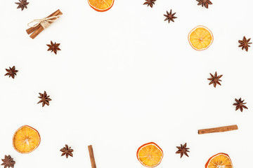 Cinnamon, banyan and dried oranges on white background. Christmas or New Year concept. Flat lay, top view.