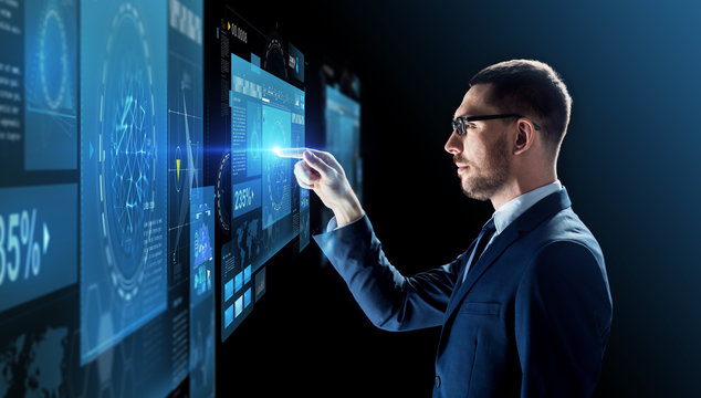 businessman in glasses with virtual projection