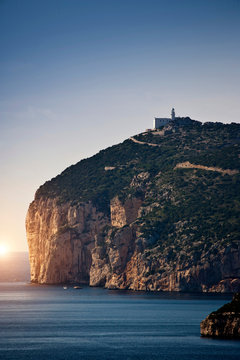 Coastal view with cliff top lighthouse, Capo Caccia, Alghero, Sardinia, Italy