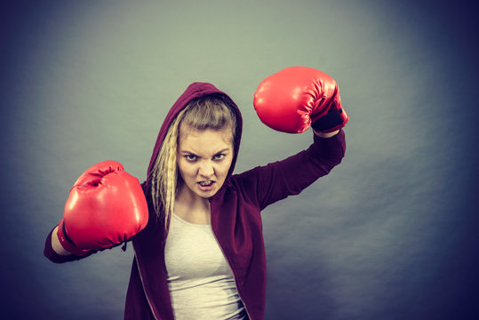Angry woman wearing boxing gloves