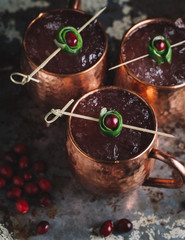 Fototapeta na wymiar Moscow Mule cocktails garnished with cranberries and lime