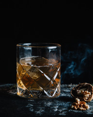 Old fashioned cocktail on dark moody background 