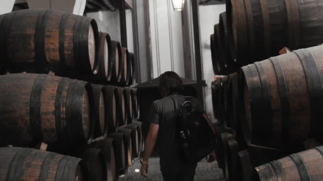 Old wine barrels in a wine cellar, sommelier man tourist dicover, porto, portugal, old factory stock