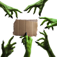 Halloween green witches or zombie monster hand holding a blank sign