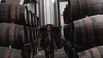 Old wine barrels in a wine cellar, sommelier man tourist dicover, porto, portugal, old factory stock
