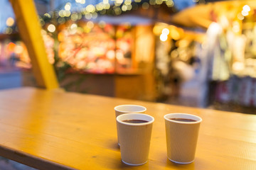 mulled wine in paper cups at christmas market