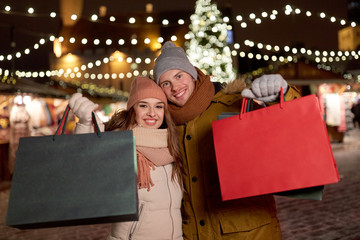 happy couple at with shopping bags in winter