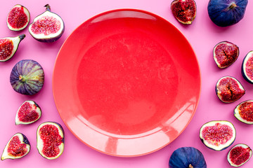Empty plate among fresh blue figs on pink background top view mockup