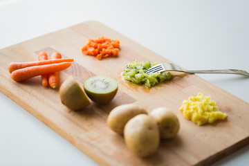 mashed fruits and vegetables with forks on board