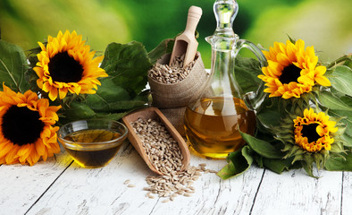 Sunflower oil, sunflower and seeds on white background