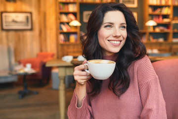 pretty woman drinking coffee in a cafe. Pleasure time - 175507033