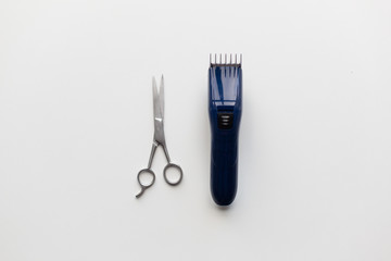 hair trimmer and scissors on white background