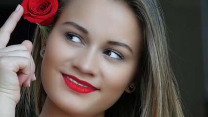 Fototapeta na wymiar Young Woman With Red Rose