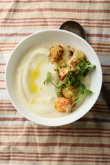 cauliflower soup with salmon in bowl