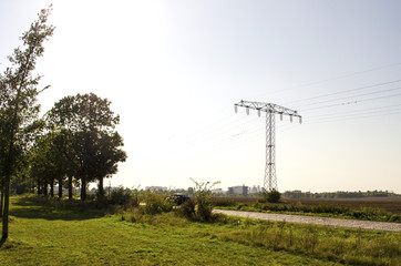Power mast near a country road in the surrounding countryside of Berlin, Germany