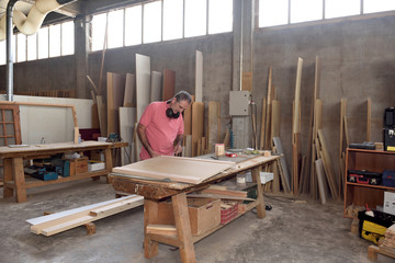 Fototapeta na wymiar a carpenter working in his workshop