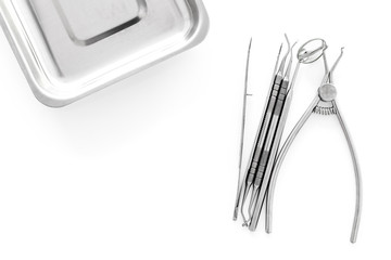 Set of dentists tools near cuvette on white background  top view copyspace