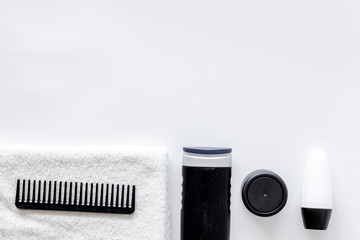 Cosmetics for men's hair on white background top view copyspace