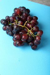 red wine grapes on blue background
