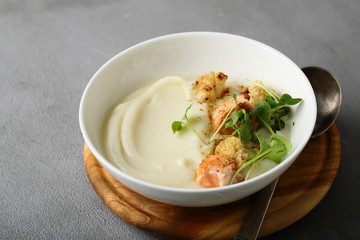 Cream-soup with salmon in bowl on concrete
