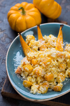 Risotto with pumpkin and parmesan, close-up, selective focus, vertical shot