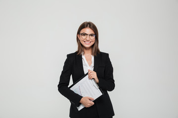 Portrait of a satisfied young businesswoman in suit