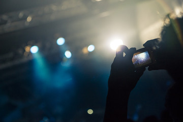 Fans filming a gig with smart phones