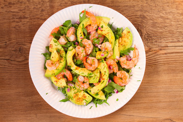 Shrimp salad with avocado arugula, scallion and almonds. View from above, top studio shot, horizontal