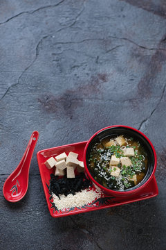 Miso soup on a grey textured asphalt background, elevated view with space, vertical shot