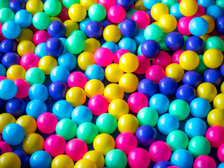 Fototapeta na wymiar Many colour plastic balls, children's party, a games room, a box filled with small colored balls
