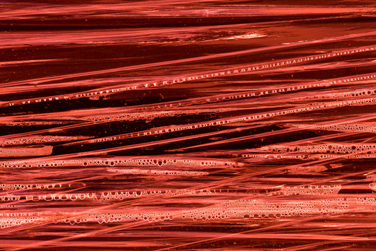 Rote Plastikfolie mit Wassertropfen