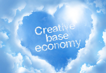 Fototapeta premium Creative base economy cloudword inside heart cloud frame on blue sky background.