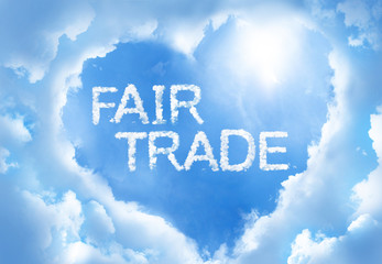 Fototapeta premium Fairtrade cloudword inside heart cloud frame on blue sky background.