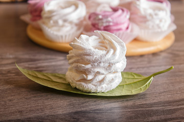  pink and white marshmallows (zephyr) on a round wooden board