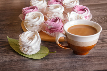  pink and white marshmallows (zephyr) on a round wooden board