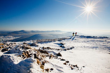 loving couple skier and snowboarder on top of the mountain, in winter in the snow. Concept weekend...
