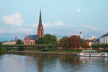 Naklejka premium Evening river, embankment and church. Frankfurt am Main, Germany