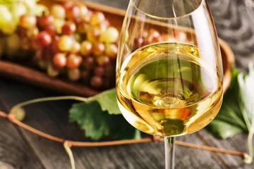 Gordijnen Glas witte wijn op vintage houten tafel © alefat