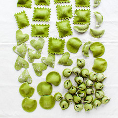 Fototapeta na wymiar Various mix of fresh homemade ravioli. Collection of green tortellini on white. ravioli, tortellini, ravioli, dumplings, heart