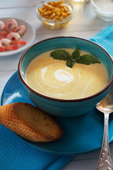 Bowl of cream soup with basil and bread