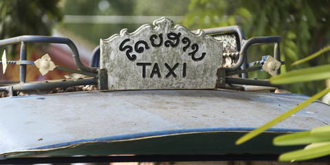 Close-up of taxi sign, Luang Prabang, Laos