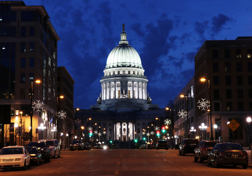 Street view with State capitol building.Wisconsin State Capitol building,National Historic Landmark.Madison,Wisconsin,USA.Night scene with official buildings and street winter decorative illumination.