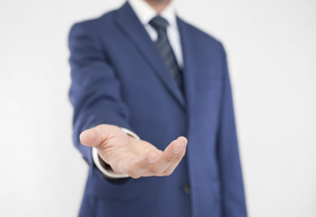 Businessman with open hand. Holding, giving, showing concept. 