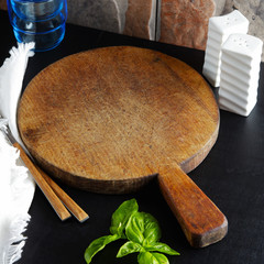 cutting board on the table. glasses and basil leaves. Dinner time